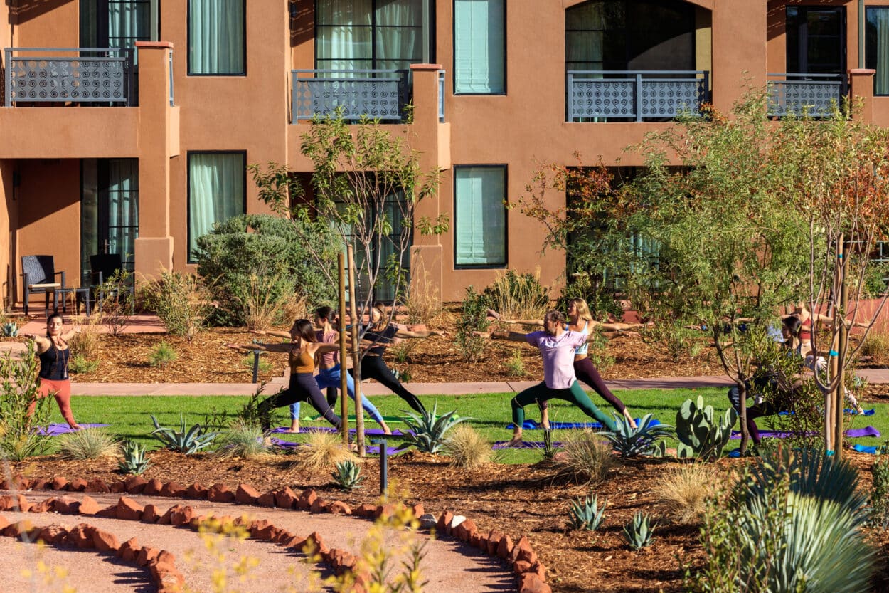 group of people doing yoga outside