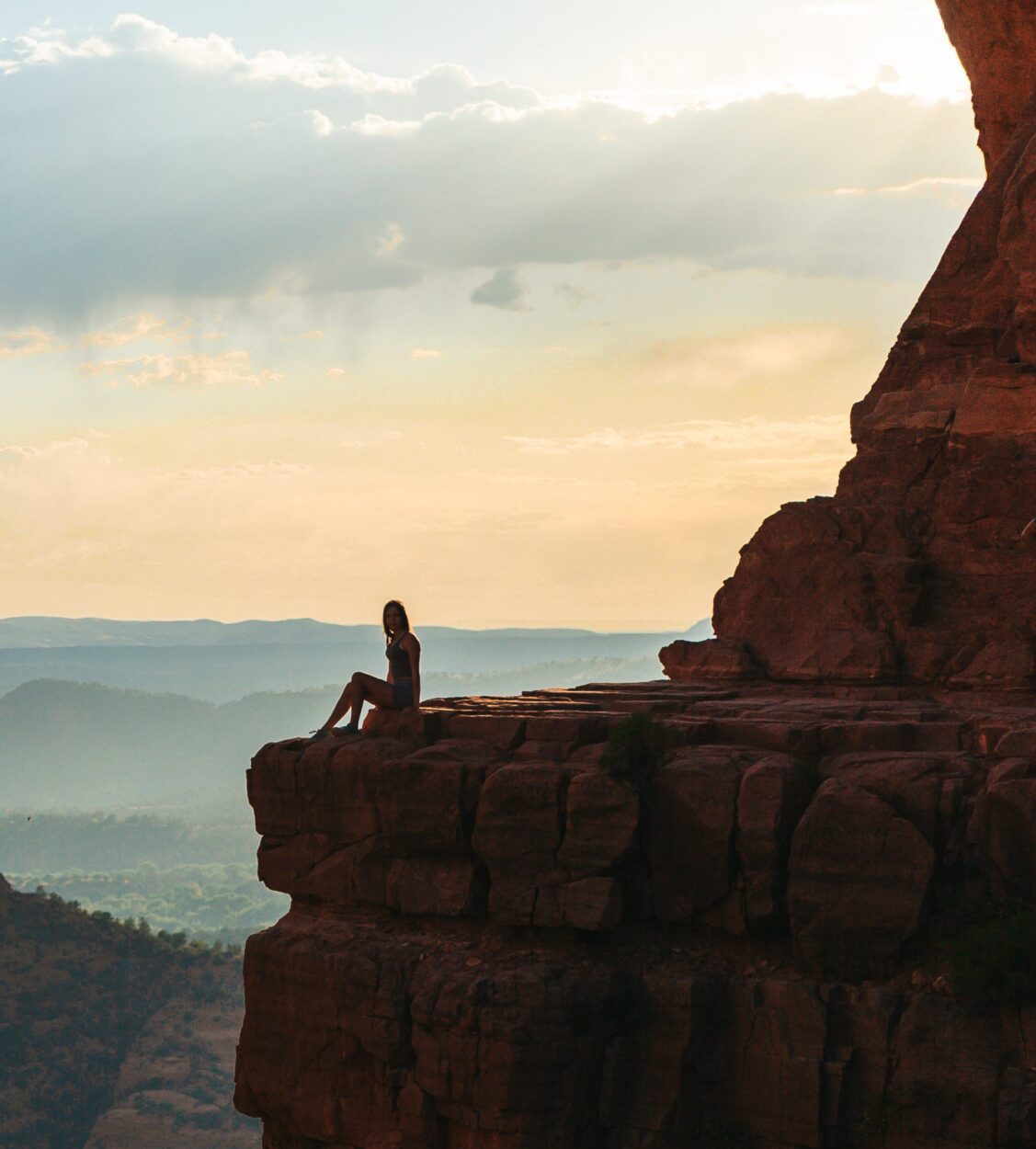 woman sat on hill edge