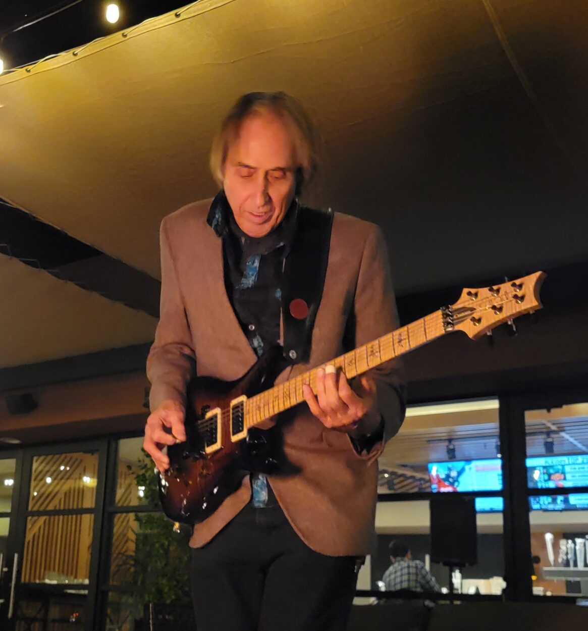 Photo of man playing guitar.